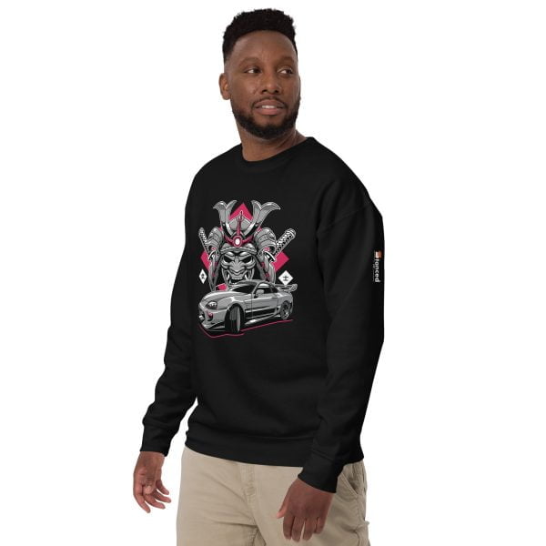 A man wearing "The Samurai" Toyota Supra MKIV Sweatshirt - Unisex Premium featuring an image of a Toyota Supra MKIV car.