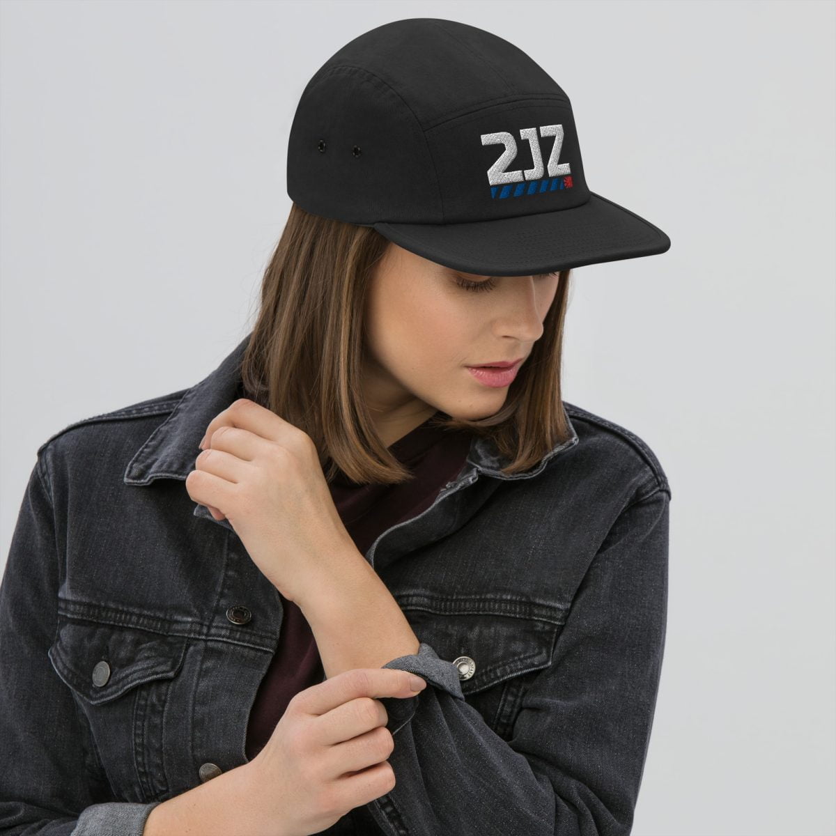 A woman in a black hat adorned with a 2JZ Five Panel Cap | StancedLife