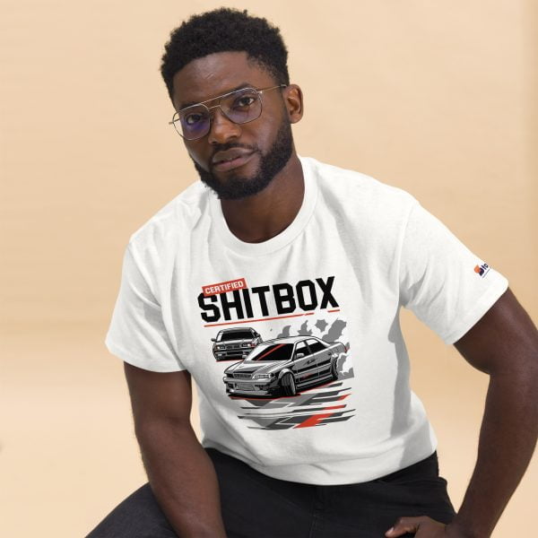 A man wearing a white t-shirt with the product name "E36 BMW & JDM JZX100 Toyota Chaser Drifting Men's T-shirt "Certified Shitbox"" printed boldly, showcasing his love for drifting and JDM cars.