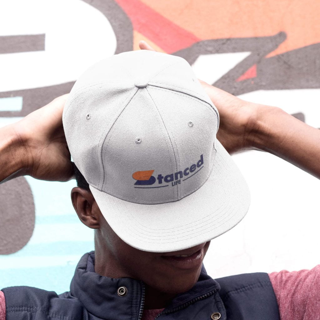 A young man wearing a snapback hat that says StancedLife.