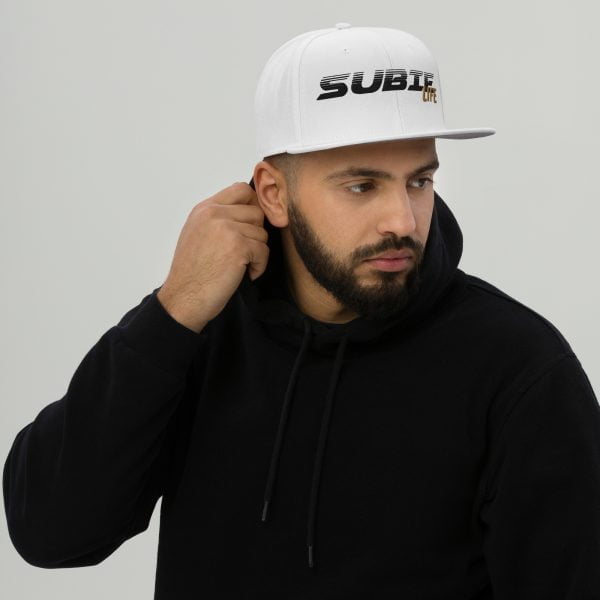 A man rocking a Subaru WRX Snapback Hat "Subie Life" with a white snapback hat, sporting a black hoodie.